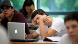 A University of Miami student studies the daily lesson plan on his computer during a Spanish language class in Coral Gables, Florida.