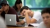 FILE - A University of Miami student studies the daily lesson plan on his computer during a Spanish language class in Coral Gables, Florida, Sept. 9, 2013.