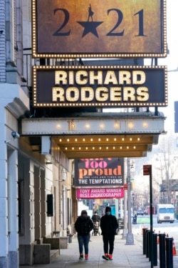 People walk past closed Broadway theaters. Photo taken on Jan. 10, 2021 (AP Photo/Mary Altaffer)