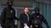 FILE - Montenegrin police officers escort South Korean citizen, Terraform Labs founder Do Kwon in Montenegro's capital Podgorica, March 23, 2024.