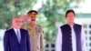 Visiting Afghan President Ashraf Ghani, left, reviews guard of honor with Prime Minister of Pakistan Imran Khan in Islamabad, Pakistan, June 27, 2019, in this photo released by the Press Information Department.