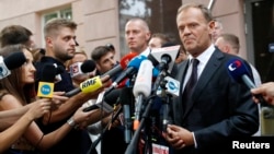 President of the European Council Donald Tusk (R) speaks to media next to the prosecutor's office in Warsaw, Poland, Aug. 3, 2017. 