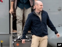 FILE - In this April 20, 2014 file photo, released French hostage Nicolas Henin arrives at the Villacoublay military airbase, outside Paris. He was released with other French journalists who had been held since June 2013.