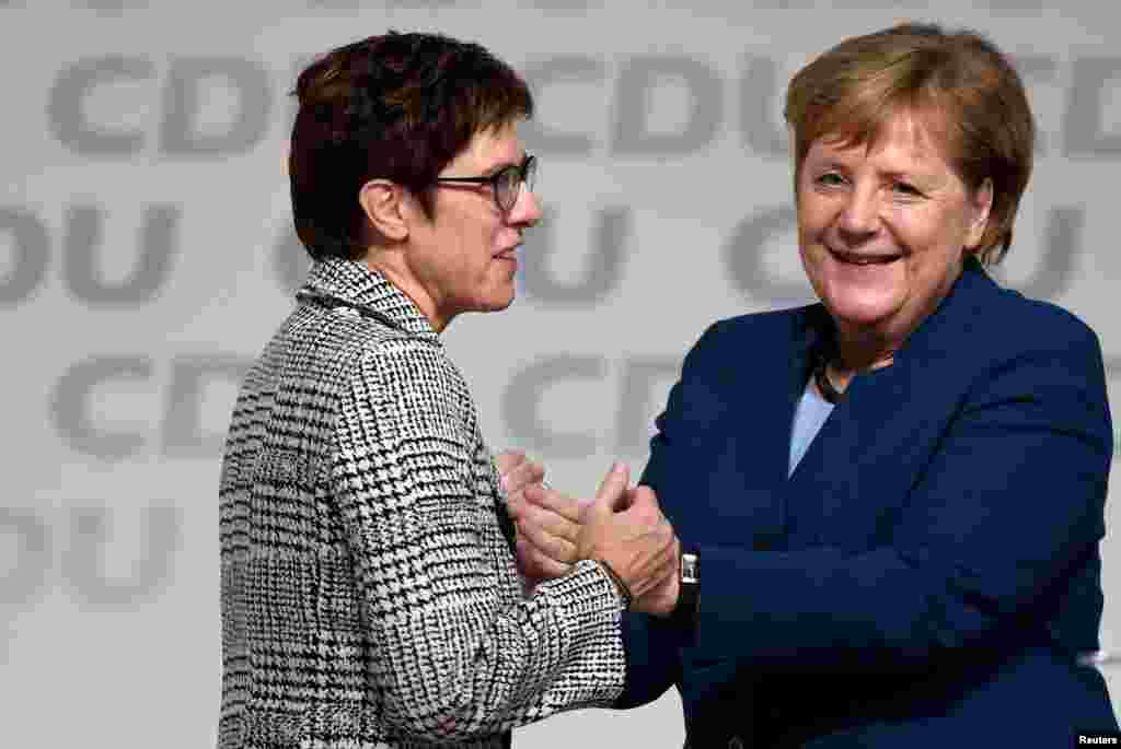 Annegret Kramp-Karrenbauer is embraced by German Chancellor Angela Merkel after being elected as the party leader during the Christian Democratic Union (CDU) party congress in Hamburg, Germany. Merkel was not running for another term.