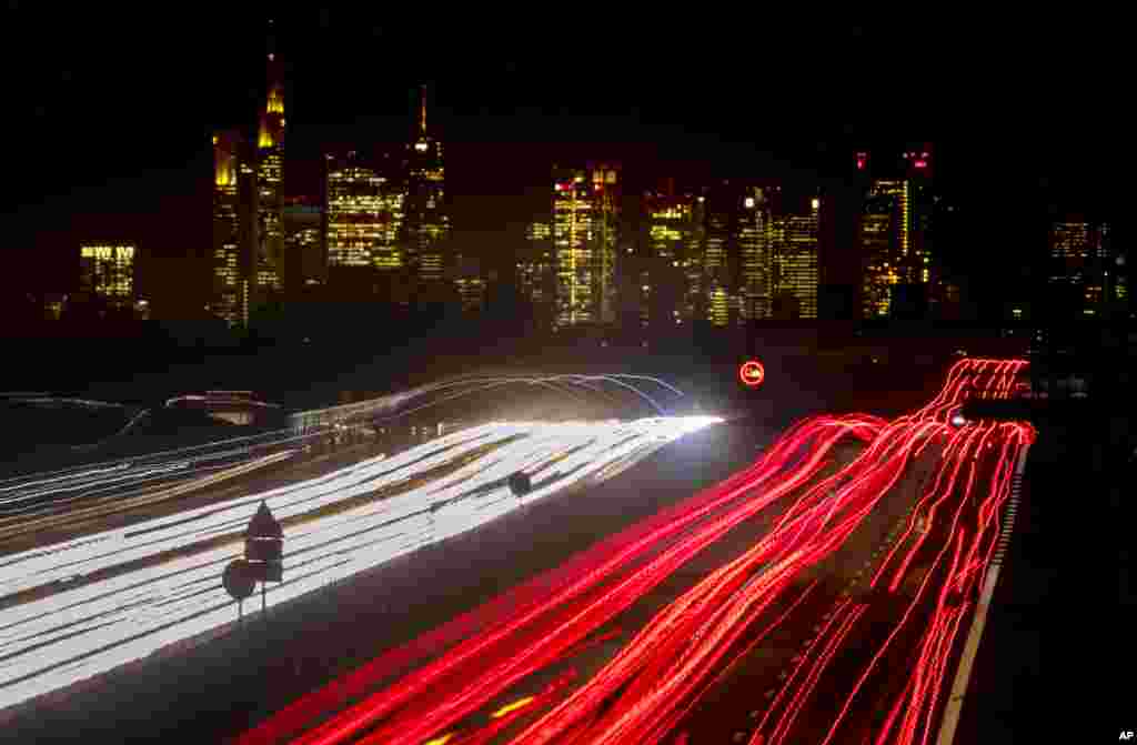 A long time exposure photo shows cars and trucks driving on a highway near Frankfurt, Germany.