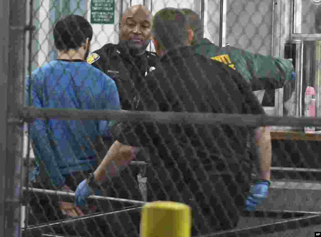 Esteban Santiago, présumé auteur de la fusillade à l&#39;aéroport de Fort Lauderdale, tenu par des policiers, en Floride, 1er janvier 2017.