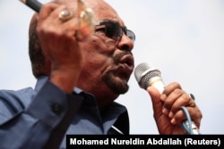 FILE - Sudan's President Omar al-Bashir addresses supporters during his visit to the war-torn Darfur region, in Bilal, Darfur, Sudan Sept. 22, 2017.