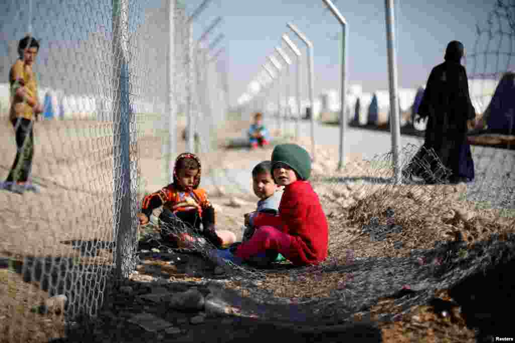 Displaced Iraqi children, who fled the Islamic State stronghold of Mosul with their families, play at Khazer refugee camp, Iraq.