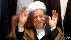  In this Dec. 21, 2015 file photo, former Iranian President Akbar Hashemi Rafsanjani waves to journalists as he registers his candidacy for the elections of the Experts Assembly, in Tehran, Iran. (AP Photo/Ebrahim Noroozi, File)