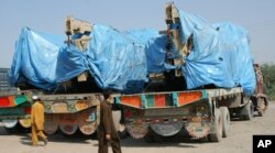 FILE - Afghanistan-bound NATO trucks are parked at a roadside as authorities blocked NATO supply line to Afghanistan after NATO allegedly killed three border guards at Pakistani border, at tribal check post of Takhta Beg in Khyber area of Pakistan near Pa