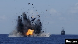The Indonesian navy scuttles foreign fishing vessels caught fishing illegally in Indonesian waters near Bitung, North Sulawesi, May 20, 2015. A total of 19 foreign boats from Vietnam, Thailand, Philippines and one from China were destroyed.