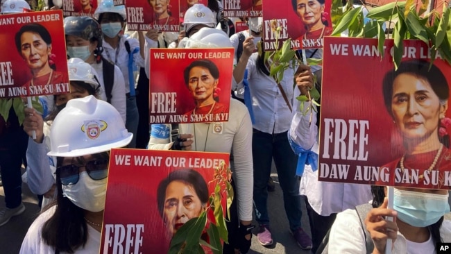 In this file photo, protesters hold portraits of ousted Myanmar leader Aung San Suu Kyi during an anti-coup demonstration in Mandalay, Myanmar on March 5, 2021. (AP Photo/File)