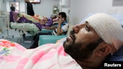 Shi'ite volunteers with the Iraqi Army, lie in hospital beds after being wounded in clashes with militants of the Islamic state, formerly known as the Islamic state in Iraqi and the Levant (ISIL), in Basra, southeast of Baghdad, Iraq, Aug. 6, 2014.