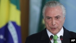 FILE - Brazil's President Michel Temer speaks during a ceremony at Planalto presidential palace in Brasilia, Brazil, June 5, 2017.