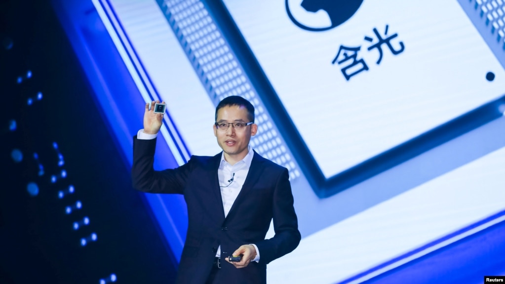 FILE - Alibaba's Chief Technology Officer (CTO) Jeff Zhang holds a new self-developed AI chip Hanguang 800 at the Alibaba Cloud Computing Conference in Yunqi of Hangzhou, Zhejiang province, China September 25, 2019. (REUTERS/Stringer)