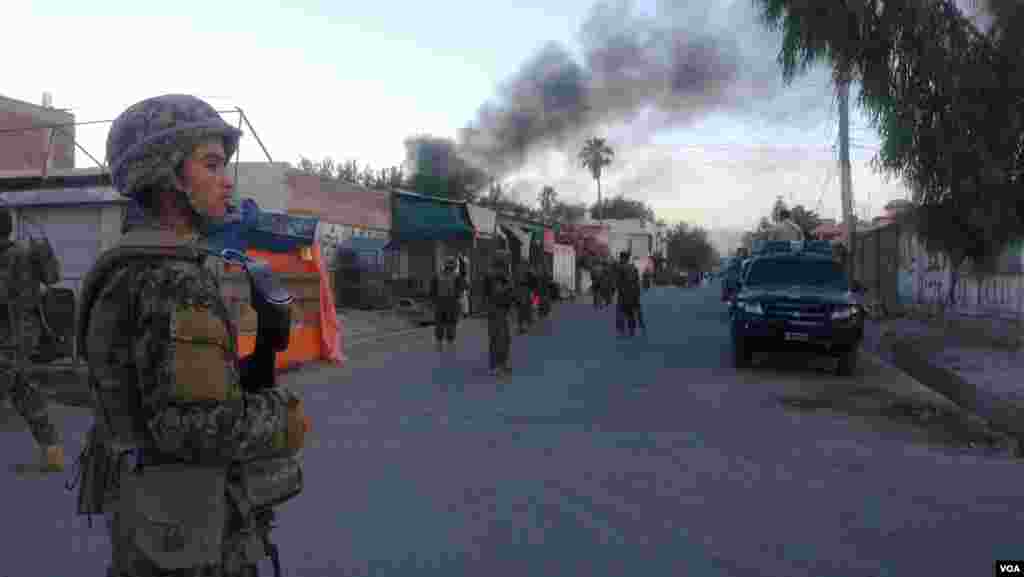 Security personnel stand guard after an attack on a Red Cross office in the eastern city of Jalalabad, Afghanistan. (Z. Hasrat/VOA)