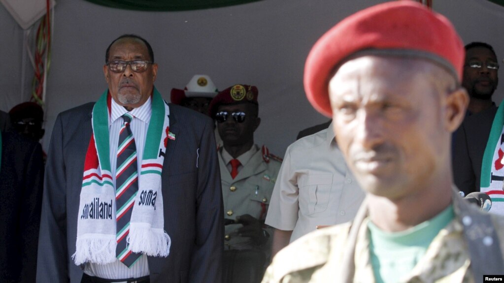 FILE - President Ahmed Mohamed Silanyo stands to salute troops during a street parade to celebrate independence day for the breakaway Somaliland nation from Somalia in the capital, Hargeysa, May 18, 2015. 