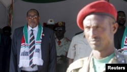 FILE - President Ahmed Mohamed Silanyo stands to salute troops during a street parade to celebrate independence day for the breakaway Somaliland nation from Somalia in the capital, Hargeysa, May 18, 2015. 