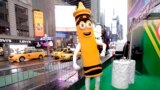 FILE - A dandelion crayon character poses for photos during a Crayola event in New York's Times Square, March 31, 2017. (AP Photo/Richard Drew)