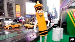 FILE - A dandelion crayon character poses for photos during a Crayola event in New York's Times Square, March 31, 2017. (AP Photo/Richard Drew)