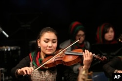 In this Feb. 15, 2017, photo, Zarifa Adiba, 18, plays during a concert in Kabul, Afghanistan.