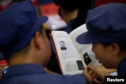 Participants read a textbook during a history lesson at the Red Culture Training Center during a Communist team-building course in Jinggangshan, Jiangxi province, China, Sept. 14, 2017.