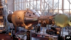 A display at the Smithsonian Air and Space Museum depicts the docking of an American Apollo command and service module, left, with a Soviet Soyuz capsule, Sunday, Dec. 7, 2014 in Washington, D.C. The July 1975 docking was part of a 1972 agreement between