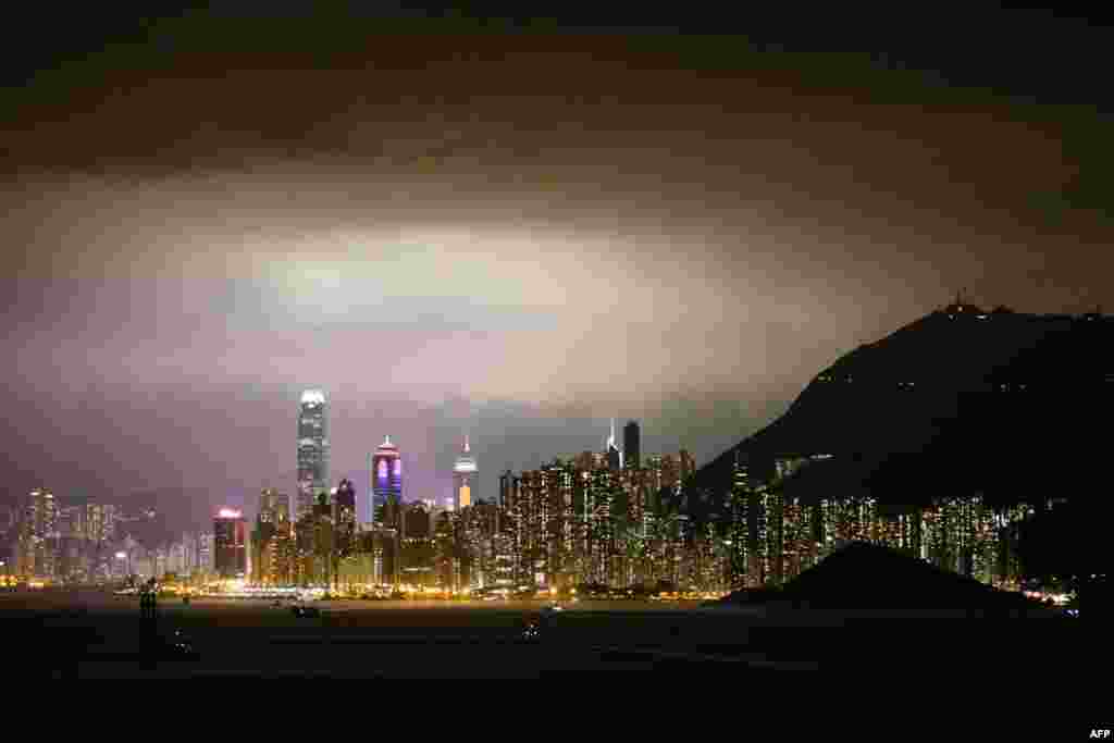 Ships sail in the waters off Hong Kong and the city&#39;s skyline, Feb. 25, 2018.