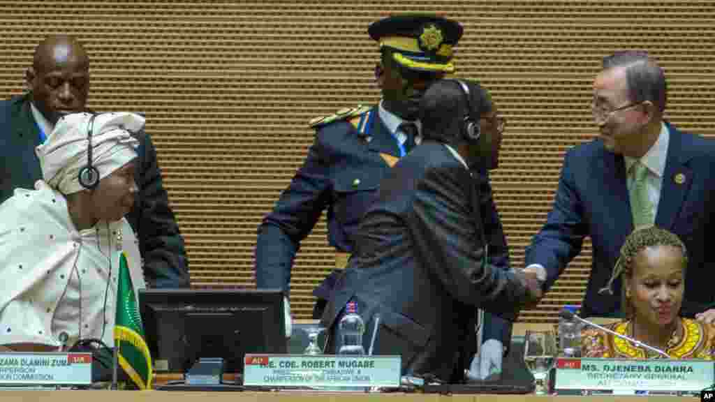 UN Secretary General, Ban Ki-moon, right, shakes hands with Zimbabwean president, Robert Mugabe, middle, as African Union Commission Chairperson Nkosazana Dlamini Zumaduring, left, watch the opening ceremony of the 26 ordinary of the African Union Summit in Ethiopian capital Addis Ababa, Saturday, Jan. 30, 2016.