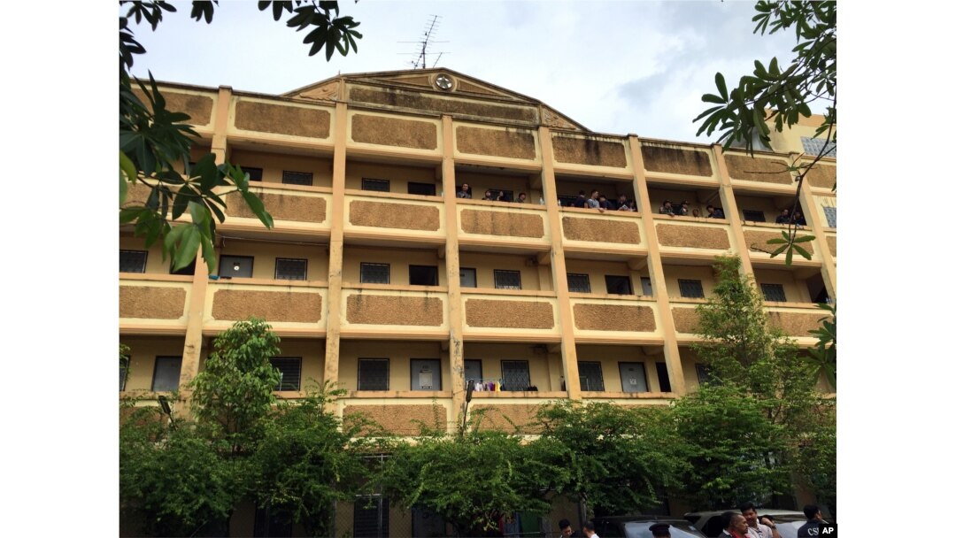 Thai police stand on the balcony outside of an apartment building in Nong Jok on the outskirts of Bangkok, Aug. 29, 2015. Thai police say they arrested a suspect in the blast at the Erawan Shrine in this apartment building.