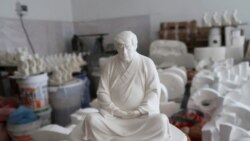 Statues of former President Donald Trump in a Buddhist meditative pose