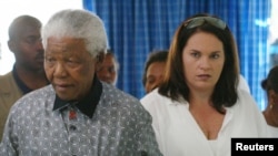 FILE - Former South African President, Nelson Mandela (L), is accompanied by his secretary Zelda Le Grange.