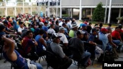 Migrants from Honduras, part of a new caravan from Central America trying to reach the United States, wait to be processed in an immigration facility in Ciudad Hidalgo, Mexico, Jan. 17, 2019.