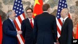 Chinese Vice Premier Liu He (R) talks with U.S. Treasury Secretary Steven Mnuchin (2nd-L), U.S. Trade Representative Robert Lighthizer (2nd-R) and U.S. Ambassador to China Terry Branstad (L) after concluding their meeting at the Diaoyutai State Guesthouse