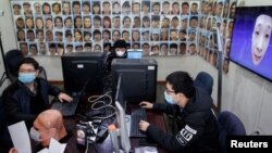 Software engineers work on a facial recognition system that identifies people when they wear a face mask at the development lab of the Chinese electronics manufacturer Hanwang.
