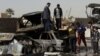 People inspect their destroyed cars at the scene of a car bomb attack in Ameen neighborhood in eastern Baghdad, Iraq, February 17, 2013.