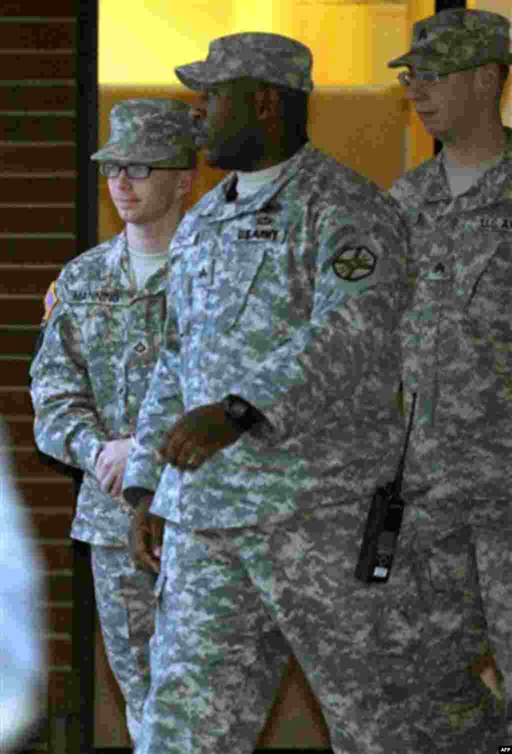 Army Pfc. Bradley Manning, left, is escorted out of a courthouse at Fort Meade, Md., Friday, Dec. 16, 2011, after the first day of a military hearing that will determine if he should face court-martial for his alleged role in the WikiLeaks classified leak