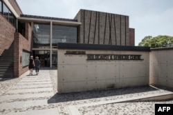 People walk toward the front entrance of the Johannesburg Holocaust & Genocide Center for its permanent exhibition inauguration in Johannesburg, March 14, 2019.