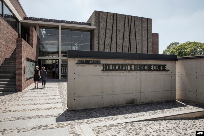 People walk toward the front entrance of the Johannesburg Holocaust & Genocide Center for its permanent exhibition inauguration in Johannesburg, March 14, 2019.