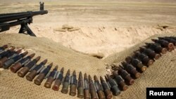 FILE - Bullets lie next to a gun at a Sinjar Resistance Units (YBS) check point, a militia affiliated with the Kurdistan Workers' Party (PKK), in the village of Umm al-Dhiban, northern Iraq, April 30, 2016. Fears are growing the mountainous region is becoming the focal point of a proxy conflict between the Iraqi Kurdistan Democratic Party (KDP) annd PKK-backed forces.