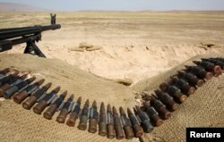 FILE - Bullets lie next to a gun at a Sinjar Resistance Units (YBS) check point, a militia affiliated with the Kurdistan Workers' Party (PKK), in the village of Umm al-Dhiban, northern Iraq, April 30, 2016.