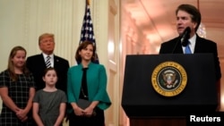 U.S. Supreme Court Associate Justice Brett Kavanaugh speaks before his ceremonial public swearing-in as U.S. President Donald Trump and Kavanaugh's wife, Ashley, and daughters Liza and Margaret look on in the East Room of the White House in Washington, Oct. 8, 2018. 