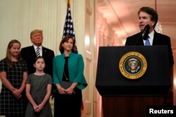 FILE - U.S. Supreme Court Associate Justice Brett Kavanaugh speaks before his ceremonial public swearing-in as U.S. President Donald Trump and Kavanaugh's wife, Ashley, and daughters Liza and Margaret look on in the East Room of the White House in Washington, Oct. 8, 2018.