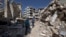 Syrian children walk between destroyed buildings in the old city of Homs, Syria, Feb. 26, 2016. 