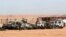 Algerian soldier stands near damaged cars used by Islamist militants during siege near the Tiguentourine Gas Plant, In Amenas, Jan. 31, 2013.