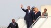 Ivory Coast's President Alassane Ouattara (L) waves next to wife Dominique (R) as they arrive at Felix Houphouet-Boigny international airport in Abidjan March 2, 2014. 