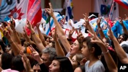 In this April 2, 2014 file photo, activists sing the national anthem during a ceremony marking the 32th anniversary of the start of the Falkland conflict, in Buenos Aires, Argentina. (AP Photo/Victor R. Caivano)