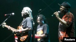 Reuben Koroma, right, and other members of Sierra Leone's Refugee All Stars perform in Gdynia, northern Poland, July 25, 2014.