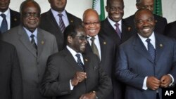 South Africa's President Jacob Zuma, center-right, and Zimbabwe's President Robert Mugabe, center-left, share a joke as Gabon's President Ali Bongo Ondimba, right, looks on at the African Union summit in Addis Ababa, Ethiopia, May 26, 2013. 