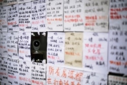 A surveillance camera is seen in a display window of a real estate agent following an outbreak of coronavirus, in downtown Shanghai, China, March 13, 2020.